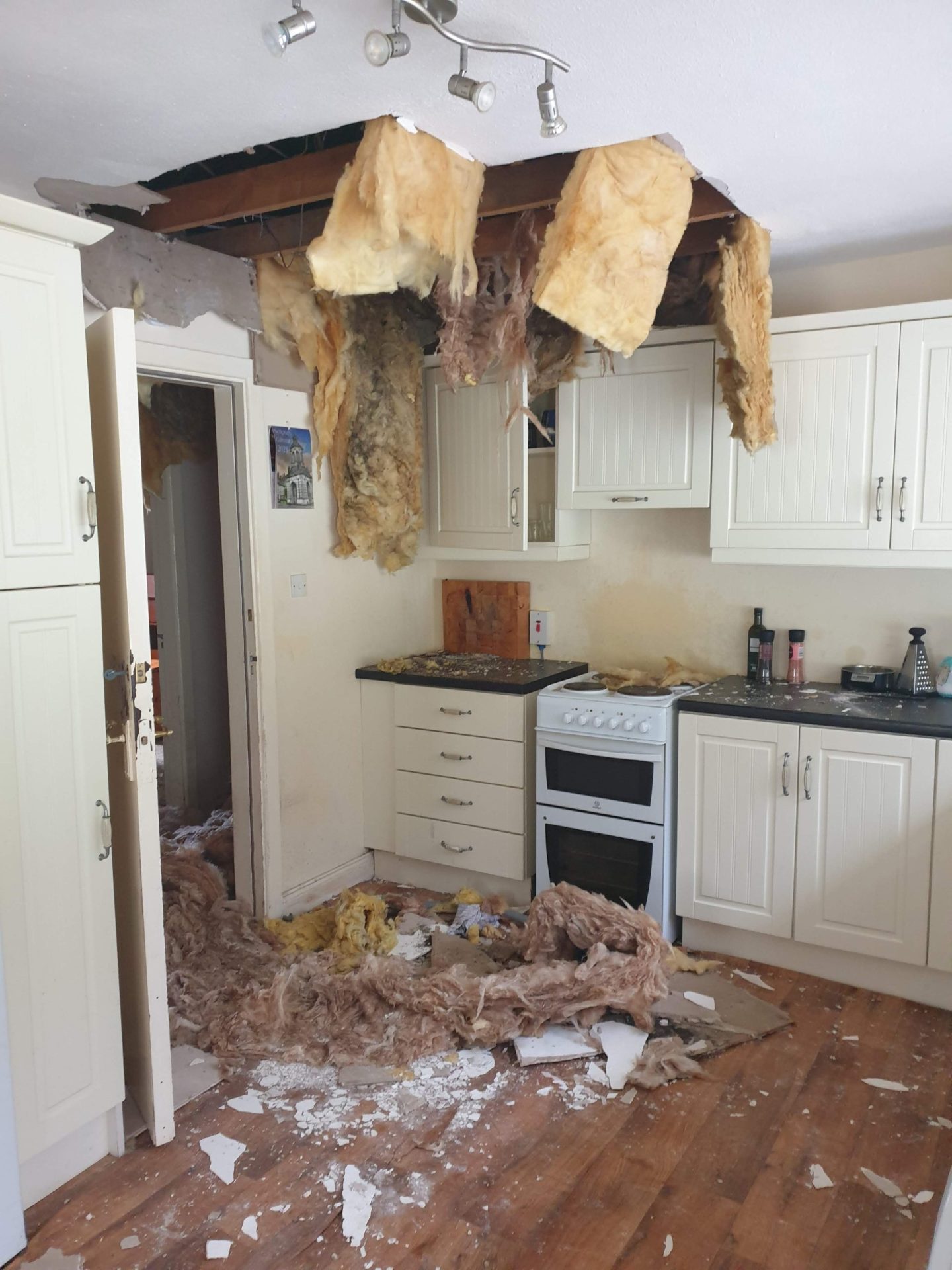 Water damage on a plasterboard ceiling and walls from a leaking pipe