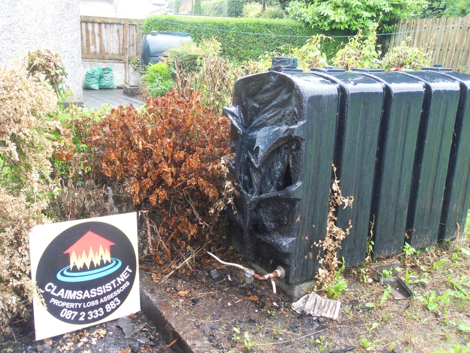 Specialist oil spill insurance assessors conducting a site survey for a domestic oil leak.