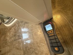 Moisture meter testing a dry-looking door frame in a Limerick home showing 50.8% hidden water content.