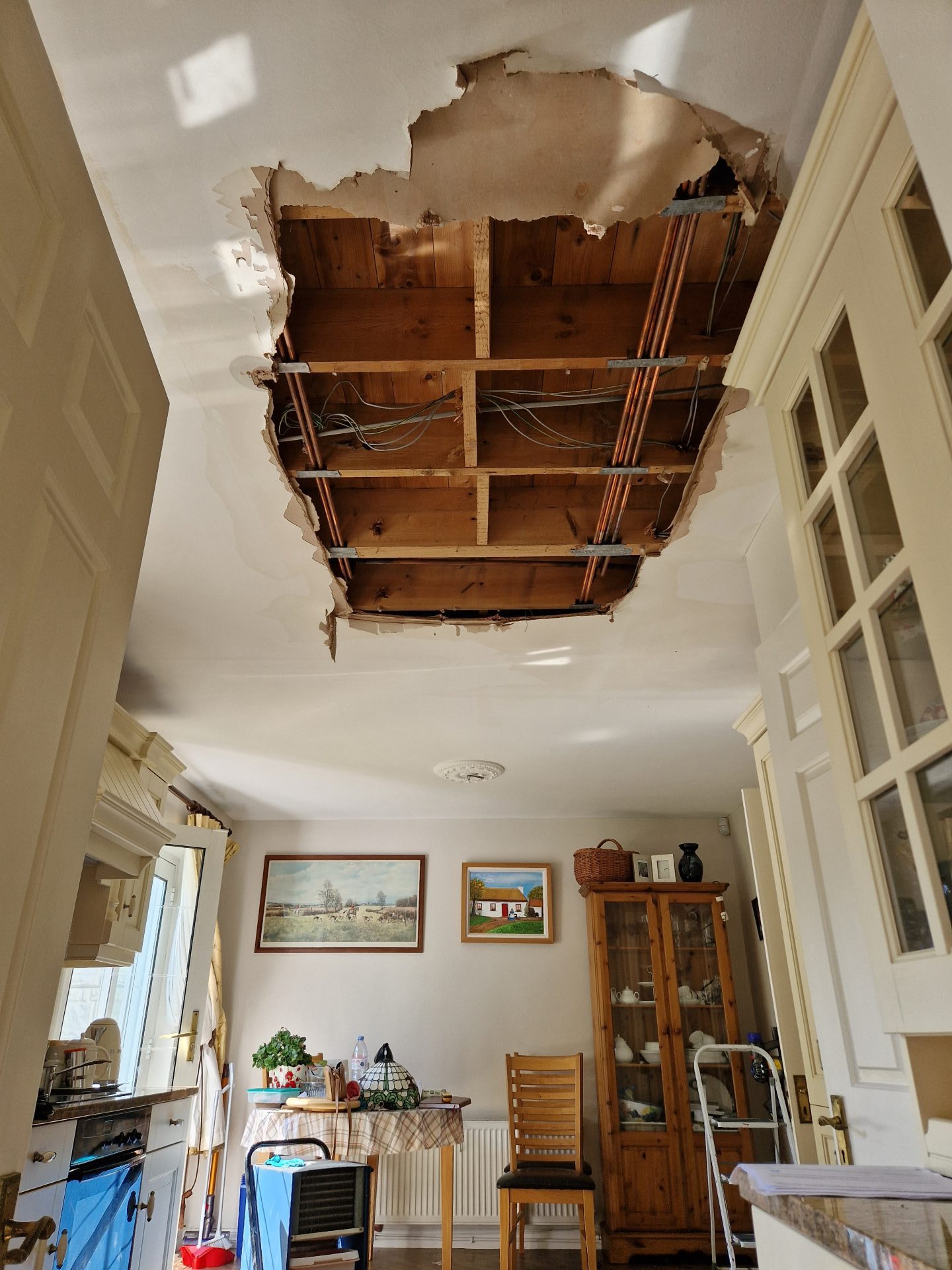 Large ceiling hole from water damage in a Limerick kitchen dining area being assessed for a home insurance claim