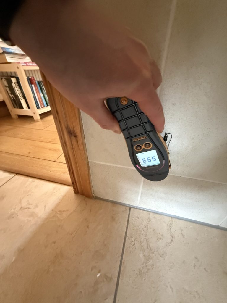 Hidden water damage behind wall tile plasterboard revealed by moisture mapping.