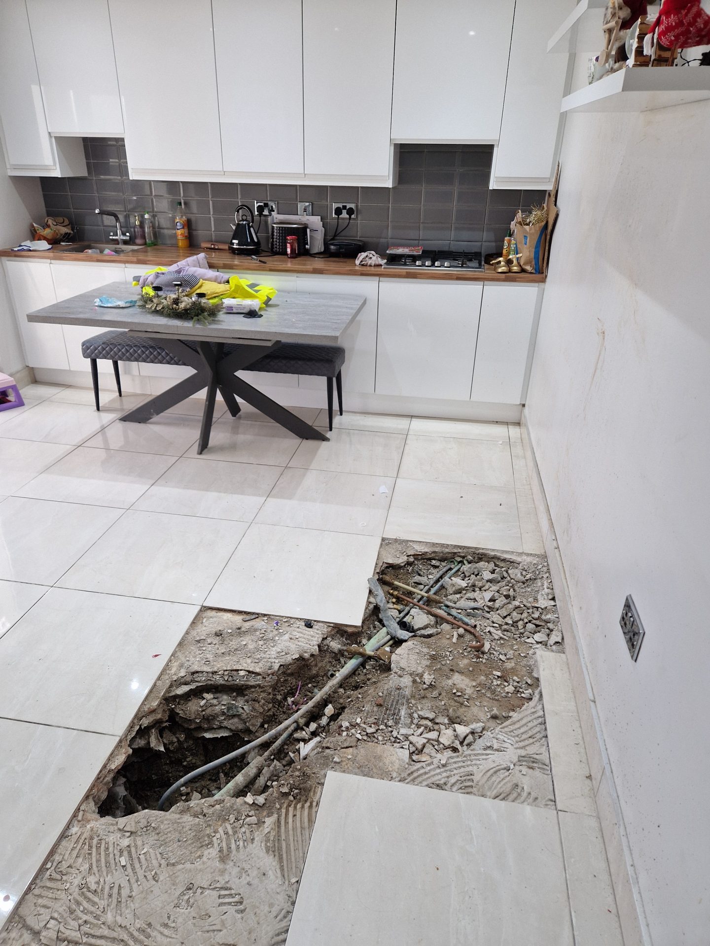 Loss assessor managing trace and access investigation for an underfloor leak insurance claim in Ireland.
