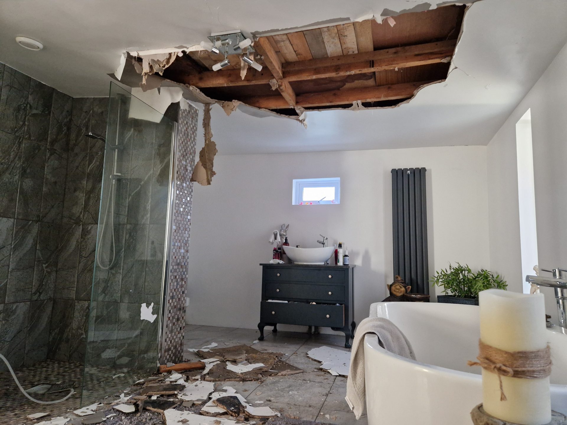 Expert water damage loss assessor inspecting a major bathroom ceiling collapse and burst pipe claim in Ireland.