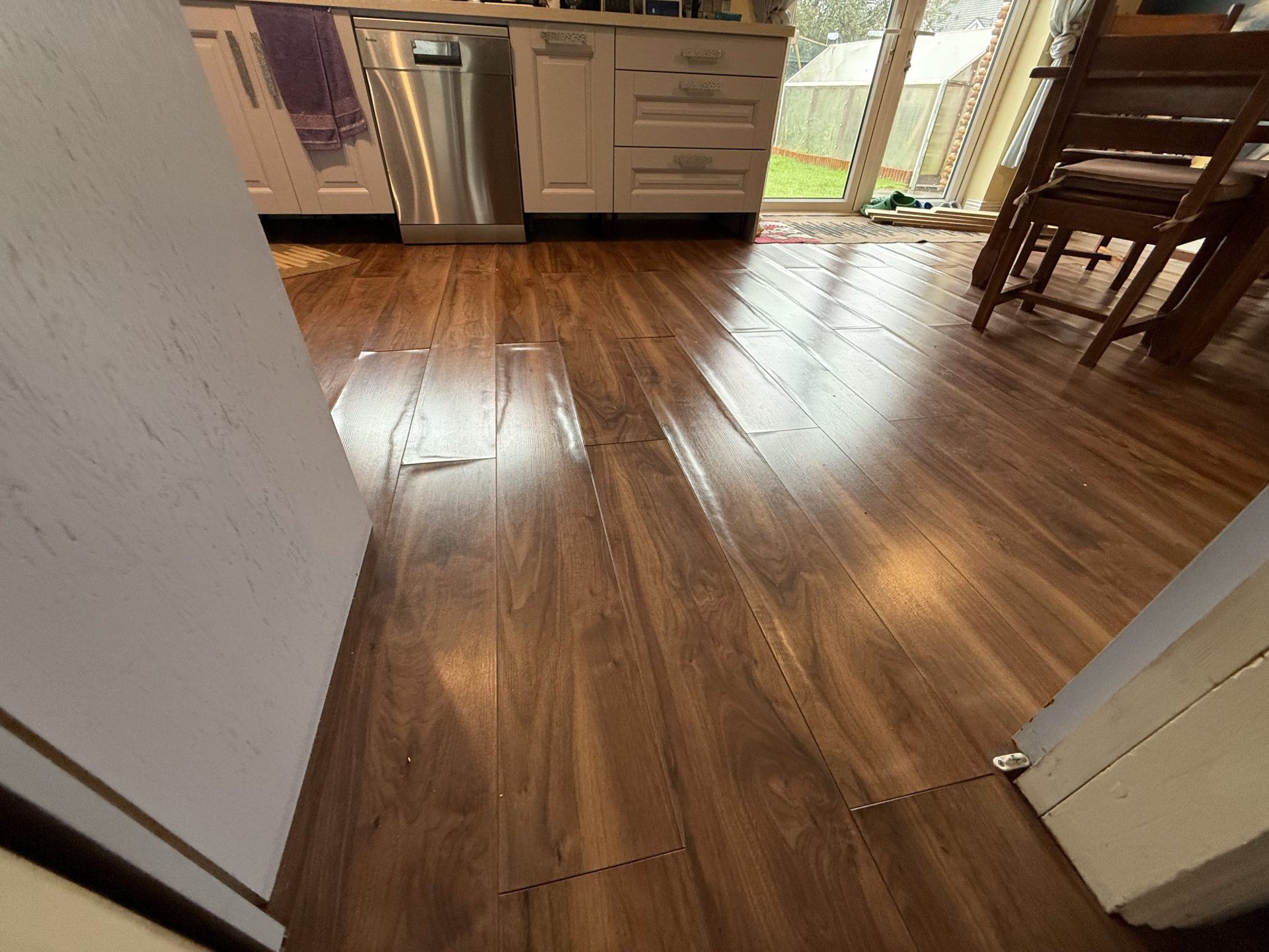 Water damaged laminate flooring with visible bubbling and distortion in an Ennis home, County Clare.